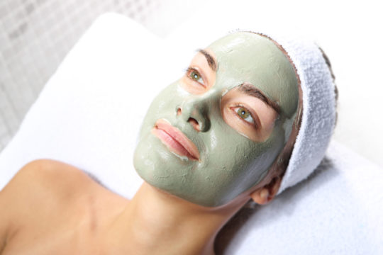 Herbal facial mask on a young woman